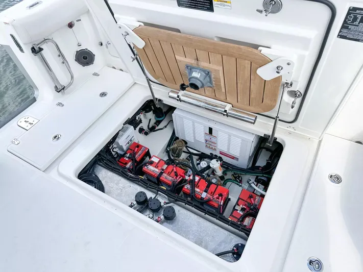  Yacht Photos Pics 2020 Boston Whaler 325 Conquest boat battery compartment with red batteries and wiring.