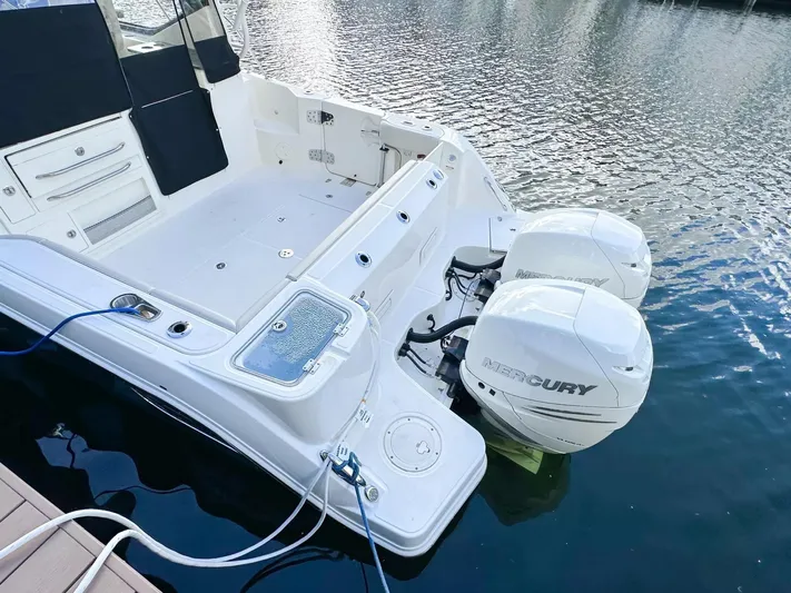  Yacht Photos Pics 2020 Boston Whaler 325 Conquest with dual Mercury outboard engines docked on water.