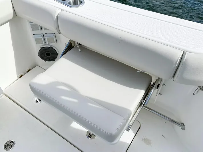  Yacht Photos Pics 2020 Boston Whaler 325 Conquest boat seat with cup holder and speaker, on water.