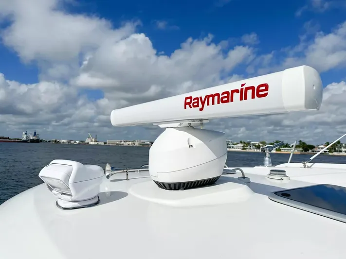  Yacht Photos Pics 2020 Boston Whaler 325 Conquest with Raymarine radar on deck, under a cloudy sky.
