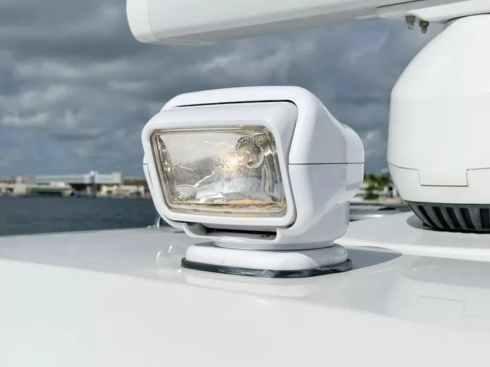  Yacht Photos Pics Close-up of spotlight on 2020 Boston Whaler 325 Conquest boat under cloudy sky.