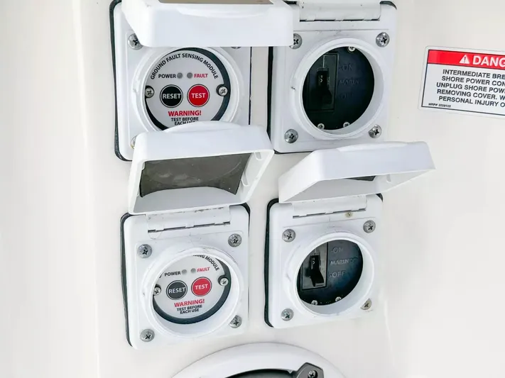  Yacht Photos Pics Electrical panel on a 2020 Boston Whaler 325 Conquest boat with safety warnings.