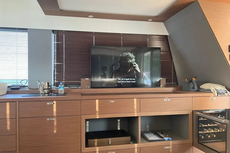 Nm03011 Yacht Photos Pics Luxurious interior of 2022 Beneteau Grand Trawler 62 with TV and wine storage.