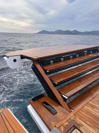  Yacht Photos Pics Luxury Evo Yachts R6+ 2025 with sleek wooden deck, cruising on open sea.