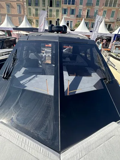  Yacht Photos Pics Evo Yachts R6+ 2025 model, sleek design, docked at a marina with tents in the background.