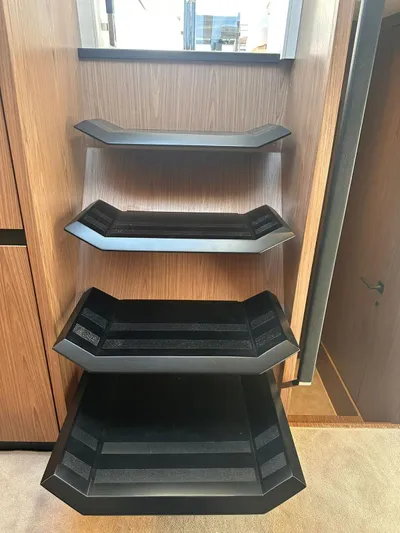  Yacht Photos Pics Modern shelving unit on Evo Yachts R6+ 2025, featuring sleek black and wood design.