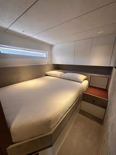  Yacht Photos Pics Luxurious bedroom interior of 2025 Evo Yachts R6+, featuring modern design and cozy bedding.
