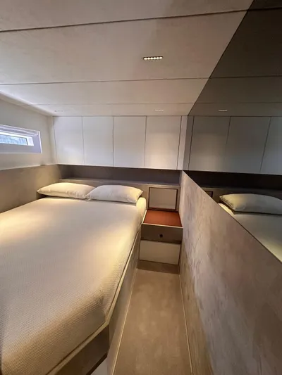  Yacht Photos Pics Luxurious bedroom interior of 2025 Evo Yachts R6+, featuring modern design and cozy bedding.