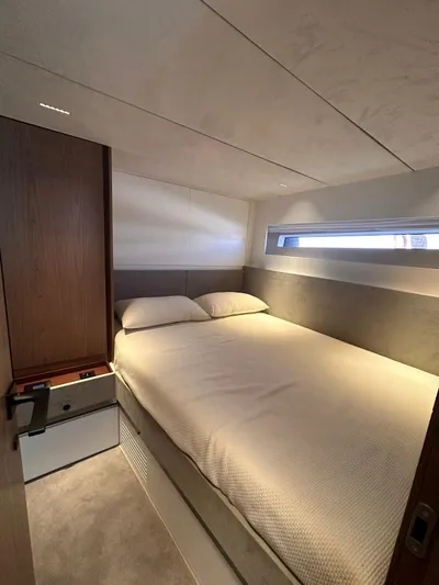  Yacht Photos Pics Luxurious cabin interior of 2025 Evo Yachts R6+, featuring a cozy bed and modern design.