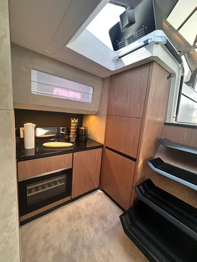  Yacht Photos Pics Modern kitchen interior of 2025 Evo Yachts R6+, featuring sleek cabinetry and appliances.