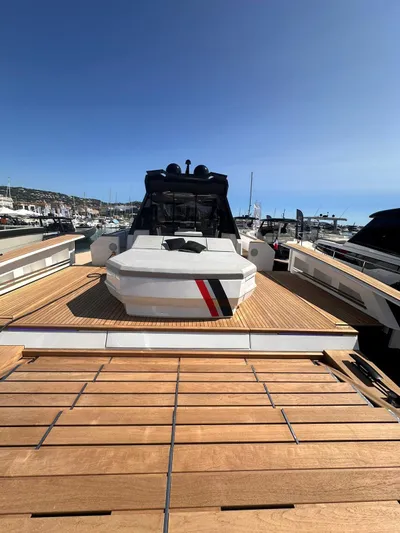  Yacht Photos Pics 2025 Evo Yachts R6+ luxury yacht docked at marina, showcasing sleek design and spacious deck.