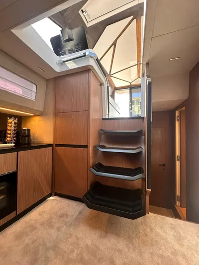 Yacht Photos Pics Interior of 2025 Evo Yachts R6+, featuring modern wood paneling and sleek staircase design.
