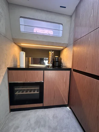  Yacht Photos Pics Modern kitchen interior of 2025 Evo Yachts R6+, featuring sleek wood cabinetry and appliances.