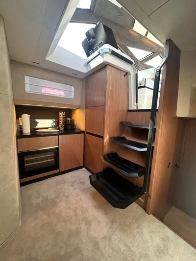  Yacht Photos Pics Interior of 2025 Evo Yachts R6+ with modern kitchen and sleek staircase design.