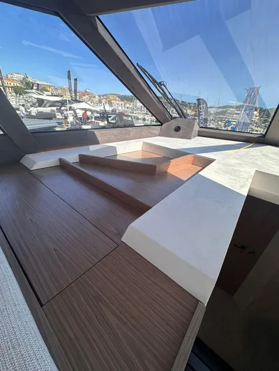  Yacht Photos Pics 2025 Evo Yachts R6+ interior with sleek wood and white design, marina view.