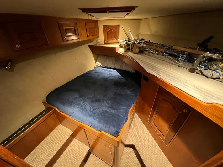 Pre Sail Yacht Photos Pics Cozy cabin interior of a 2000 Blackwell Carolina Custom boat with fishing rods.