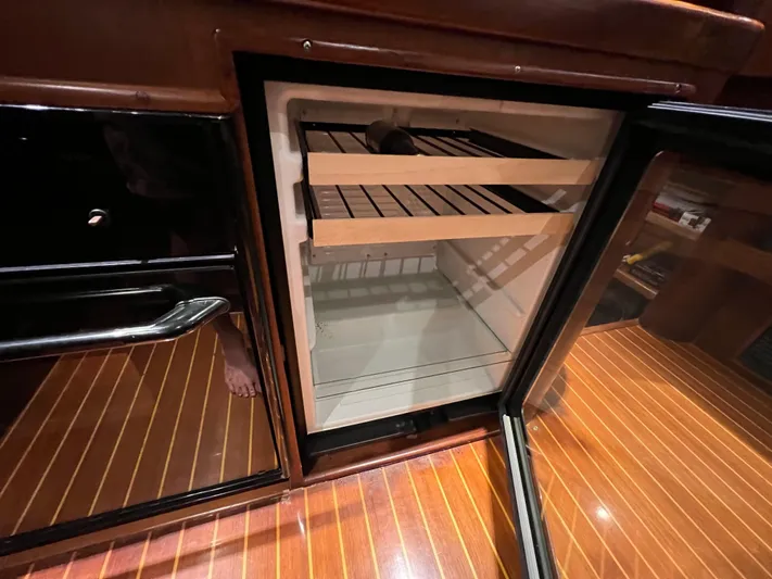 Pre Sail Yacht Photos Pics Open refrigerator in a 2000 Blackwell Carolina Custom boat with wooden interior.