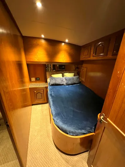 Pre Sail Yacht Photos Pics Cozy cabin interior of a 2000 Blackwell Carolina Custom boat with wooden finishes.
