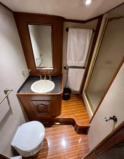 Pre Sail Yacht Photos Pics 2000 Blackwell Carolina Custom yacht bathroom with wooden flooring, sink, mirror, and shower.