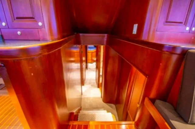 Pre Sail Yacht Photos Pics Interior of 2000 Blackwell Carolina Custom yacht with polished wooden stairs and cabinetry.
