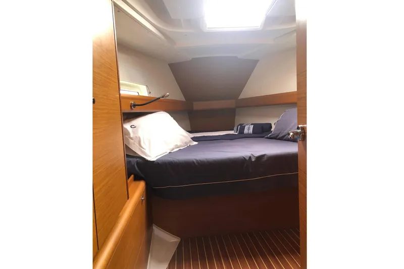  Yacht Photos Pics Cozy cabin interior of 2018 Jeanneau Sun Odyssey 419 sailboat with wooden finish.
