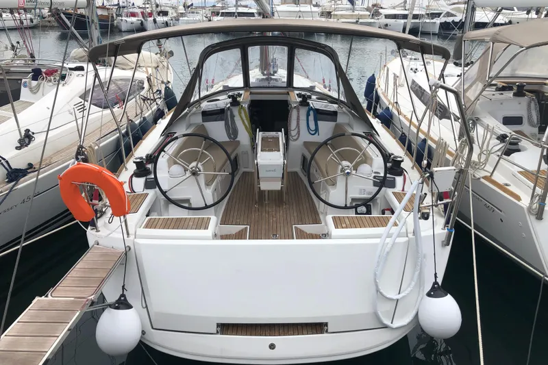  Yacht Photos Pics 2018 Jeanneau Sun Odyssey 419 sailboat docked at marina, featuring dual steering wheels.