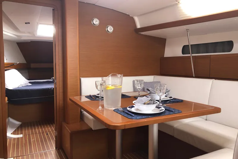  Yacht Photos Pics Interior of 2018 Jeanneau Sun Odyssey 419 yacht with dining area and cabin.