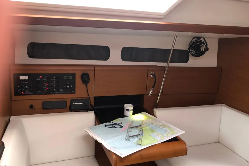  Yacht Photos Pics Navigation station inside 2018 Jeanneau Sun Odyssey 419 sailboat with map and control panel.