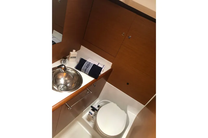 Yacht Photos Pics Bathroom interior of 2018 Jeanneau Sun Odyssey 419 yacht, featuring sink and toilet.