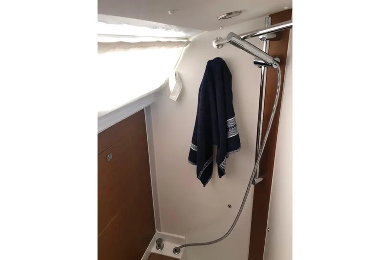  Yacht Photos Pics Shower area in 2018 Jeanneau Sun Odyssey 419 yacht with towel and showerhead.