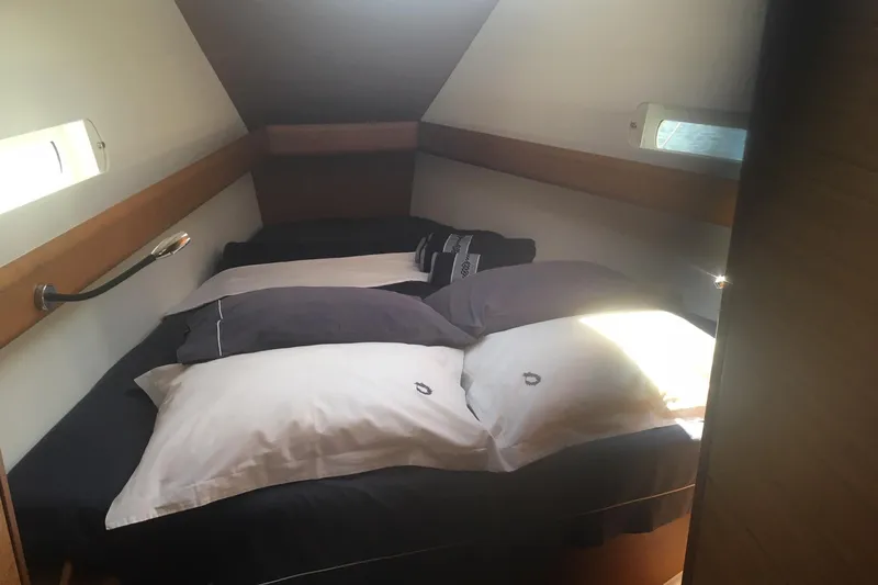  Yacht Photos Pics Cozy cabin interior of 2018 Jeanneau Sun Odyssey 419 sailboat with comfortable bedding.