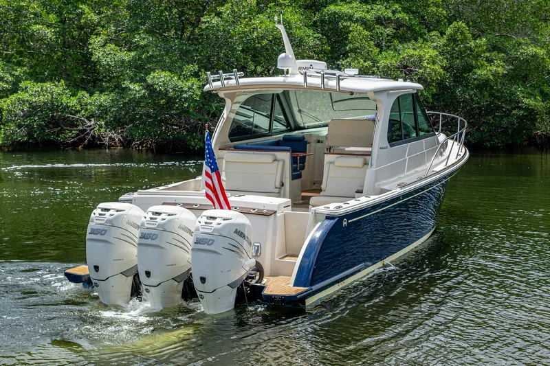 Yes Day Yacht Photos Pics 2021 Hinckley Sport Boat 40 X with triple outboard engines on a serene waterway.