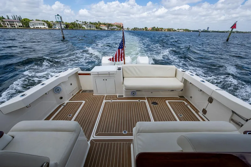 Yes Day Yacht Photos Pics Hinckley Sport Boat 40 X 2021 cruising on water, featuring spacious deck and seating.