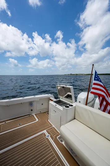 Yes Day Yacht Photos Pics Hinckley Sport Boat 40 X, 2021 model, with American flag, on open water under blue sky.
