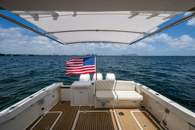Yes Day Yacht Photos Pics 2021 Hinckley Sport Boat 40 X on open water, American flag, sunny day.