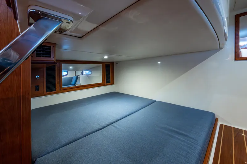 Yes Day Yacht Photos Pics 2021 Hinckley Sport Boat 40 X cabin interior with cozy bed and wooden accents.