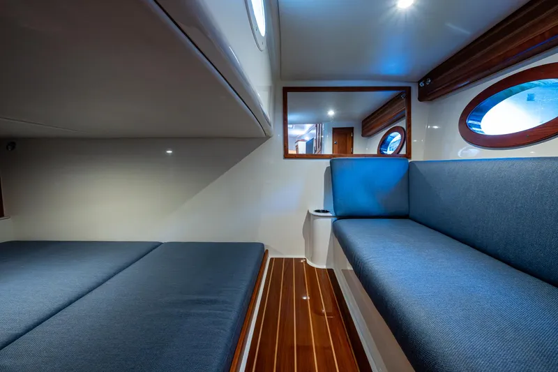 Yes Day Yacht Photos Pics Interior of 2021 Hinckley Sport Boat 40 X with blue seating and wooden flooring.