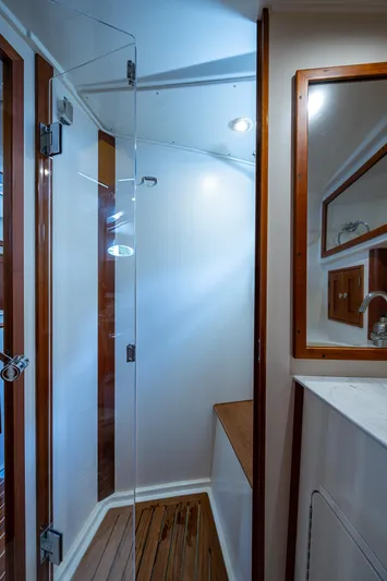Yes Day Yacht Photos Pics 2021 Hinckley Sport Boat 40 X interior bathroom with glass shower door and wooden accents.