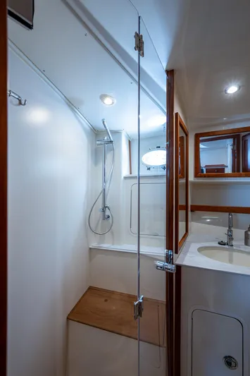 Yes Day Yacht Photos Pics 2021 Hinckley Sport Boat 40 X bathroom with shower, wooden accents, and modern fixtures.
