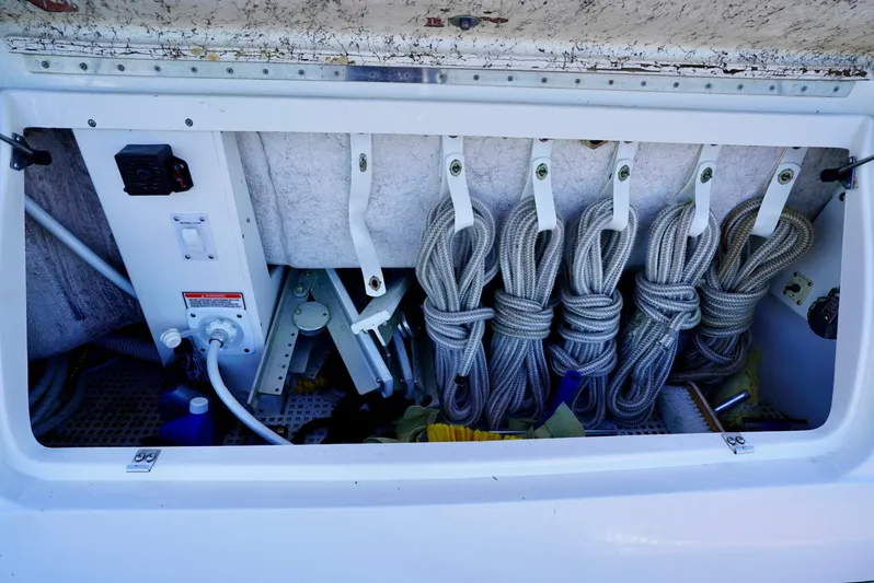 Cheaper II Keep Her Yacht Photos Pics Storage compartment on a 2002 Sea Ray 480 Sedan Bridge with coiled ropes and equipment.