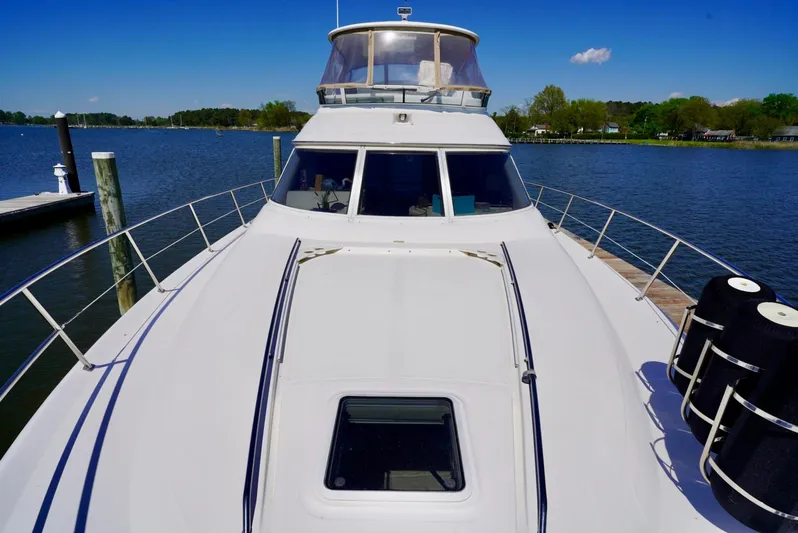 Cheaper II Keep Her Yacht Photos Pics 2002 Sea Ray 480 Sedan Bridge yacht docked on a sunny day.