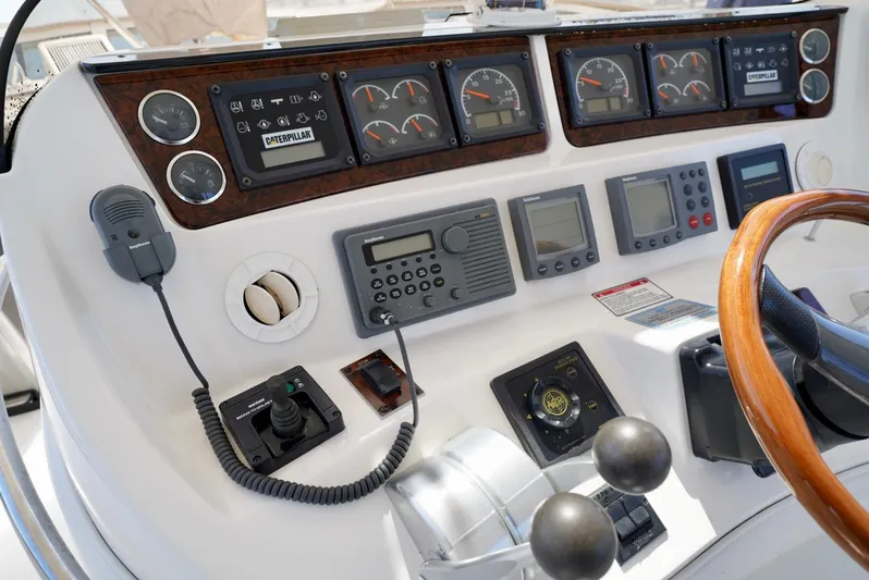 Cheaper II Keep Her Yacht Photos Pics Control panel of a 2002 Sea Ray 480 Sedan Bridge yacht with various gauges and instruments.