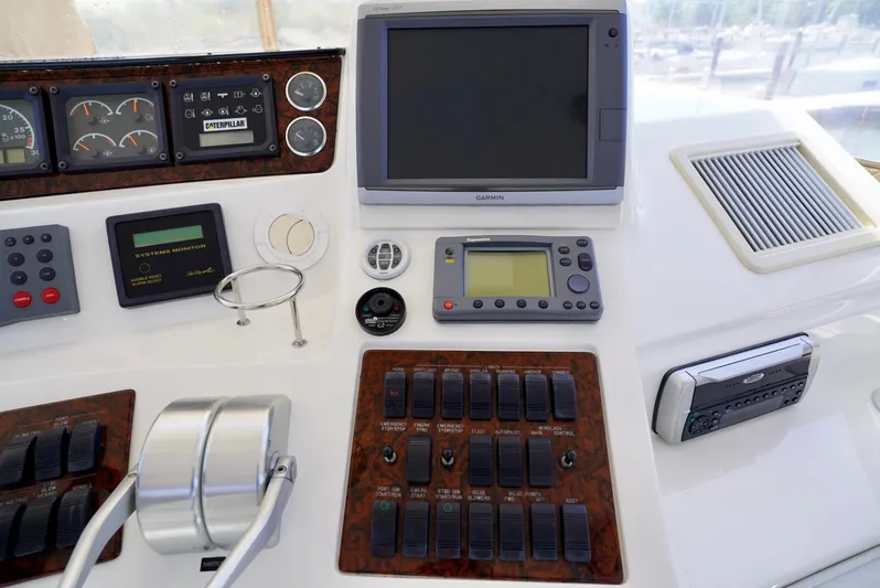 Cheaper II Keep Her Yacht Photos Pics Control panel of a 2002 Sea Ray 480 Sedan Bridge yacht with navigation and monitoring systems.