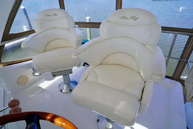 Cheaper II Keep Her Yacht Photos Pics Luxurious captain chairs on a 2002 Sea Ray 480 Sedan Bridge yacht.