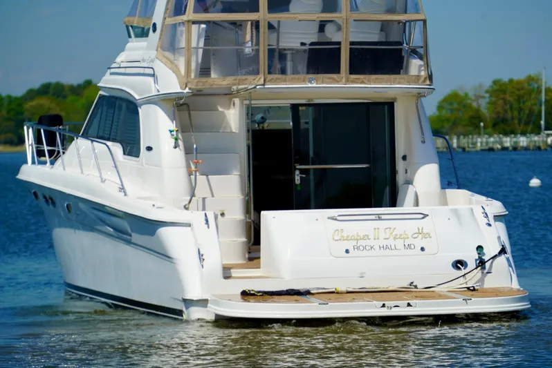 Cheaper II Keep Her Yacht Photos Pics 2002 Sea Ray 480 Sedan Bridge yacht on water, rear view.