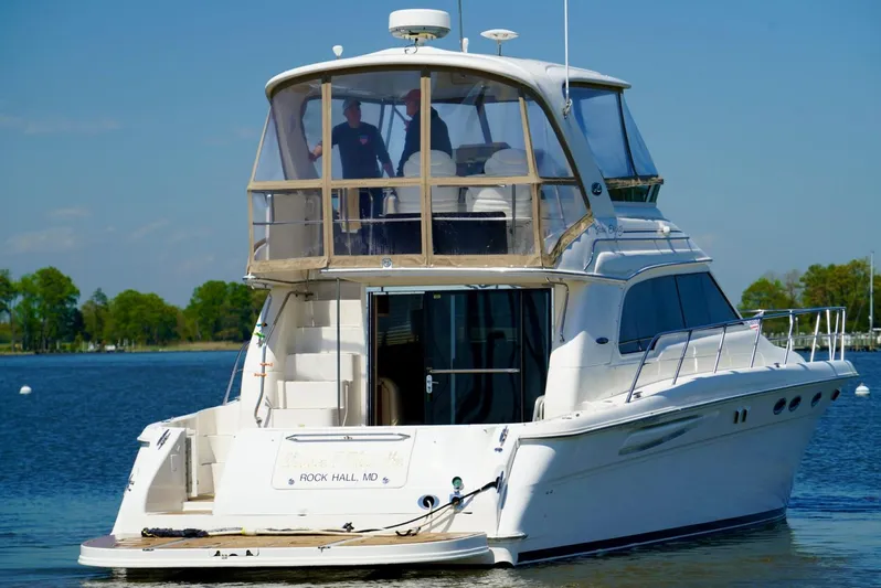 Cheaper II Keep Her Yacht Photos Pics 2002 Sea Ray 480 Sedan Bridge yacht on calm water.