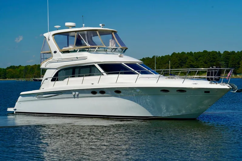 Cheaper II Keep Her Yacht Photos Pics 2002 Sea Ray 480 Sedan Bridge yacht on calm water.
