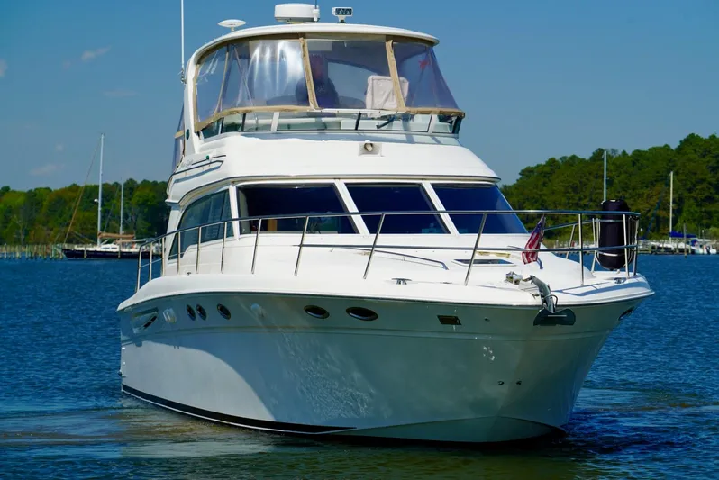 Cheaper II Keep Her Yacht Photos Pics 2002 Sea Ray 480 Sedan Bridge yacht on the water.