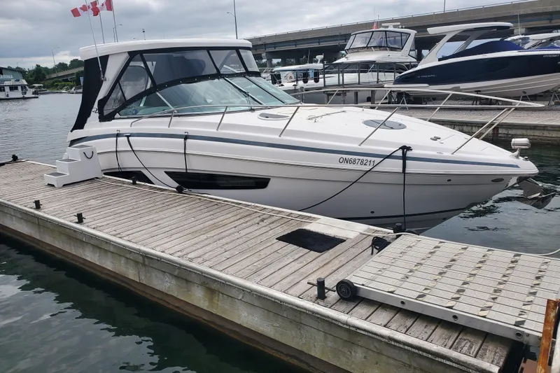 Loml Yacht Photos Pics 2020 Regal 33 Express boat docked at marina with Canadian flags.
