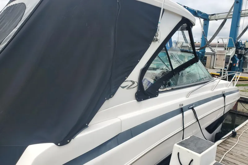 Loml Yacht Photos Pics 2020 Regal 33 Express boat docked, featuring sleek design and black canopy.